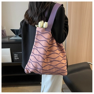 Detailed knit shoulder bag showing pink woven texture and purple wave pattern accents
