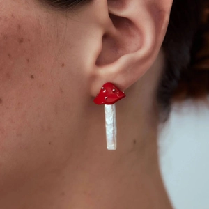 Handcrafted mushroom earrings featuring red glaze caps and baroque freshwater pearl stems