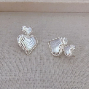 Textured double heart stud earrings in silver finish with vintage milgrain edges