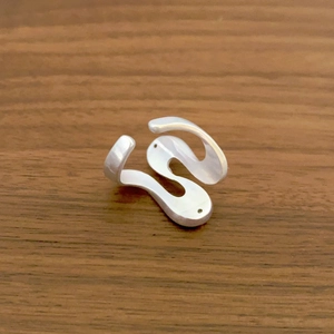 Minimalist silver wave ring with S-shaped fluid lines and polished mirror metallic finish