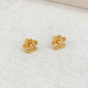 Pink zircon flower earrings with five petals in gold finish on white fabric