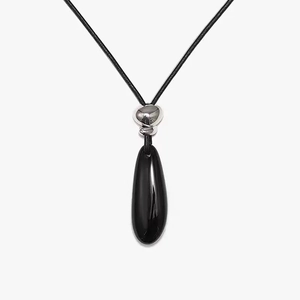 Macro shot of minimalist black teardrop pendant necklace with glossy mirror finish
