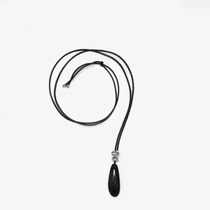 Elegant teardrop black onyx pendant necklace with a black cord on a white background