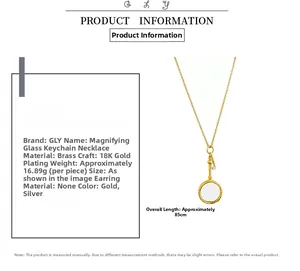 Detail of 18K gold plated brass magnifier necklace with key design and 85cm long chain