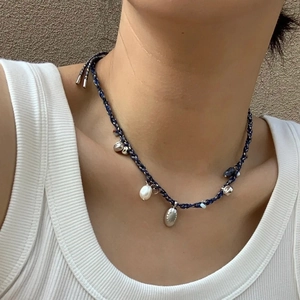 Boho style woven rope necklace with shell pendant and freshwater pearl detail for women