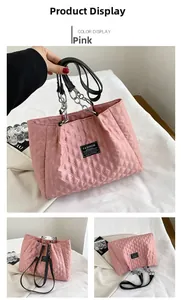 Detailed view of quilted pink nylon tote with Fashion Instinct label and chain strap