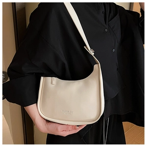 Detail of a creamy white HOBO underarm bag with Fashion Bag New York text branding