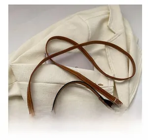Close-up of the vintage monogram fabric detail and adjustable leather shoulder strap