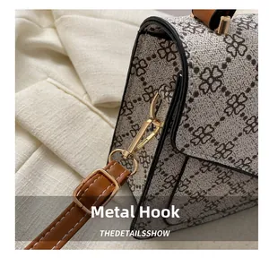 Detailed macro view of the gold-tone metal hardware hook on the vintage floral bag