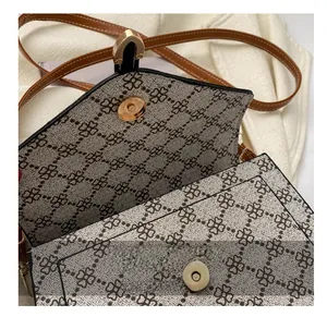 Close-up of durable magnetic snap button and vintage clover pattern on shoulder bag