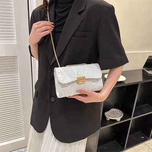 White chain shoulder bag with embossed floral texture and gold lock for women