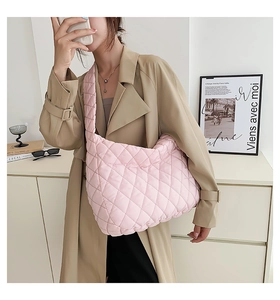 Pink quilted crossbody tote bag shown on model with soft puffer diamond pattern