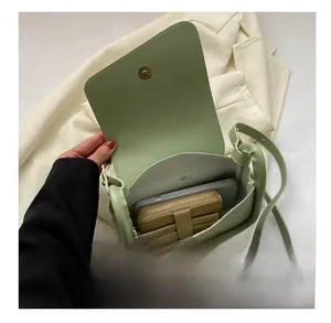 Interior view showing the capacity of the green saddle bag for smartphone and wallet