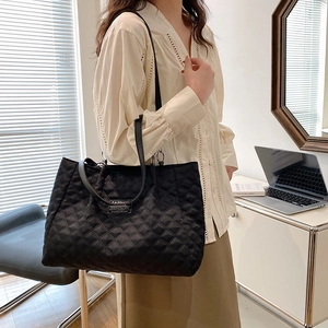 Black quilted nylon tote bag for women with fashion label and long woven shoulder straps