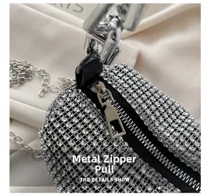 Close-up of sparkling rhinestone handbag detailing with silver metal hardware zipper pull