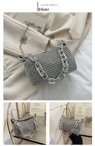 Detail of silver rhinestone square handbag with chain strap and handle for evening events