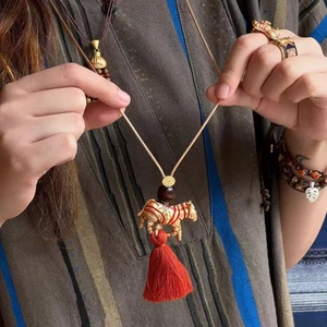 Ethnic zebra tiger gold pendant necklace with red tassel and long sweater chain