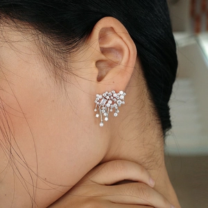 Sparkling tassel earrings with white pearls and zircons on model for a stylish look