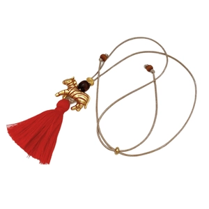 Ethnic zebra pendant necklace with gold plating and red tassel on woven cord