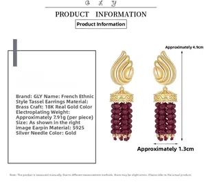Détails de boucles d'oreilles vintage à pampilles dorées avec perles rouges et tiges en argent