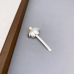 Ethnic style silver flower hair clip with textured petals and a white cultured pearl