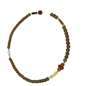 Handmade necklace with citrine pearls and tiger eye beads on white background