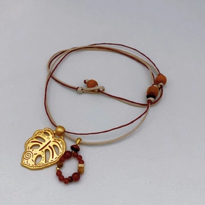 Boho Monstera leaf pendant necklace with handmade woven cord and wooden beads