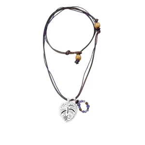 Bohemian monstera leaf pendant necklace with purple stones and wooden beads on white backdrop