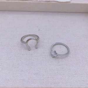 Close-up of S925 silver horseshoe ring with cubic zirconia and emerald-cut solitaire ring