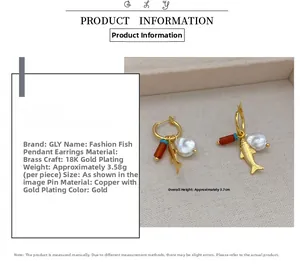 Detail showing measurement of gold fish earrings with baroque pearl and brass plating