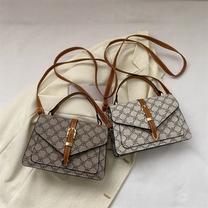 Vintage monogram shoulder bag with brown leather trim and golden hardware accents