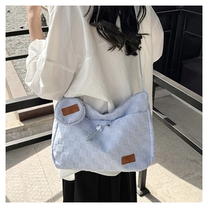 Detail of light blue checkered canvas tote bag with drawstring closure and mini pouch