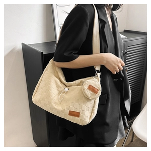Detail of checkered canvas tote bag with adjustable strap and small round coin purse