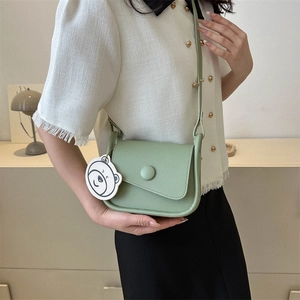 Retro light green leather saddle bag with round buckle and cute white bear charm