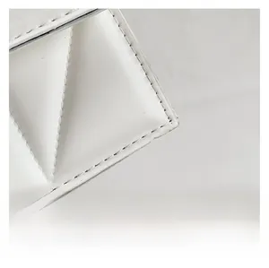 Detail showing high-quality white leather texture and precise stitching on chain bag