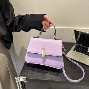Lavender trapezoid crossbody bag with gold flame lock and leather texture for women