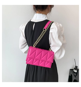 Detailed back view of a pink geometric quilted crossbody bag with a gold chain strap