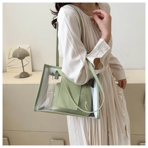 Detailed shot of transparent PVC tote bag with light green inner pouch and slim shoulder strap