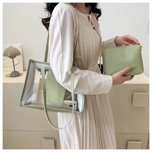 Pale green transparent PVC tote bag and leather clutch set worn by a model