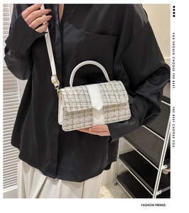 Model wearing a cream tweed small square bag with textured weave and leather straps