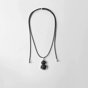 Pendentif gourde en ébène avec cadre argenté sur cordon noir minimaliste chic