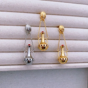 Vintage amphora earrings set with red agate beads and gold plated textured metal details