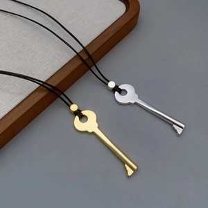 Fashionable key pendant necklace in gold and silver finish with black cord strap