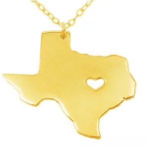 Macro shot of Texas map pendant in gold finish with heart cutout and delicate O-chain