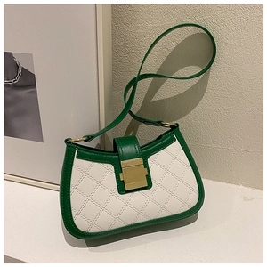 Macro detail of retro green and white contrast handbag with quilted stitching and gold lock