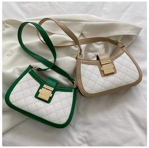 Detail of color-block shoulder bags featuring quilted white leather and gold metal locks