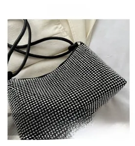 Detailed macro view of black square bag with shimmering silver rhinestones in a grid pattern