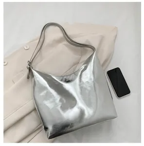 Silver metallic Hobo tote bag showing large capacity with smartphone for scale
