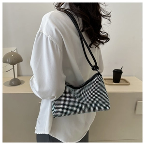 Detail of rhinestone shoulder bag with black leather strap and sparkling crystal finish