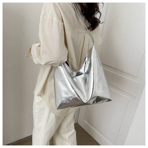Detail of glossy metallic silver tote bag showing reflective finish and large capacity